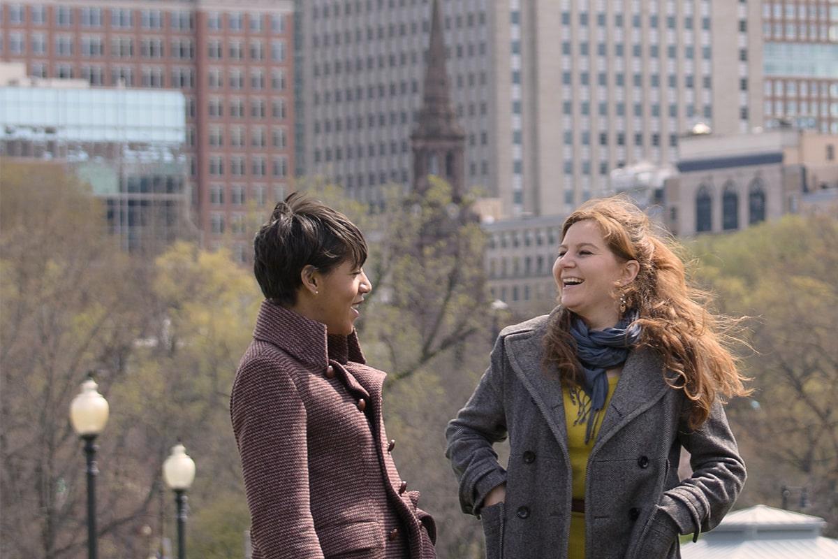 Two women in wool coats on Boston Common.